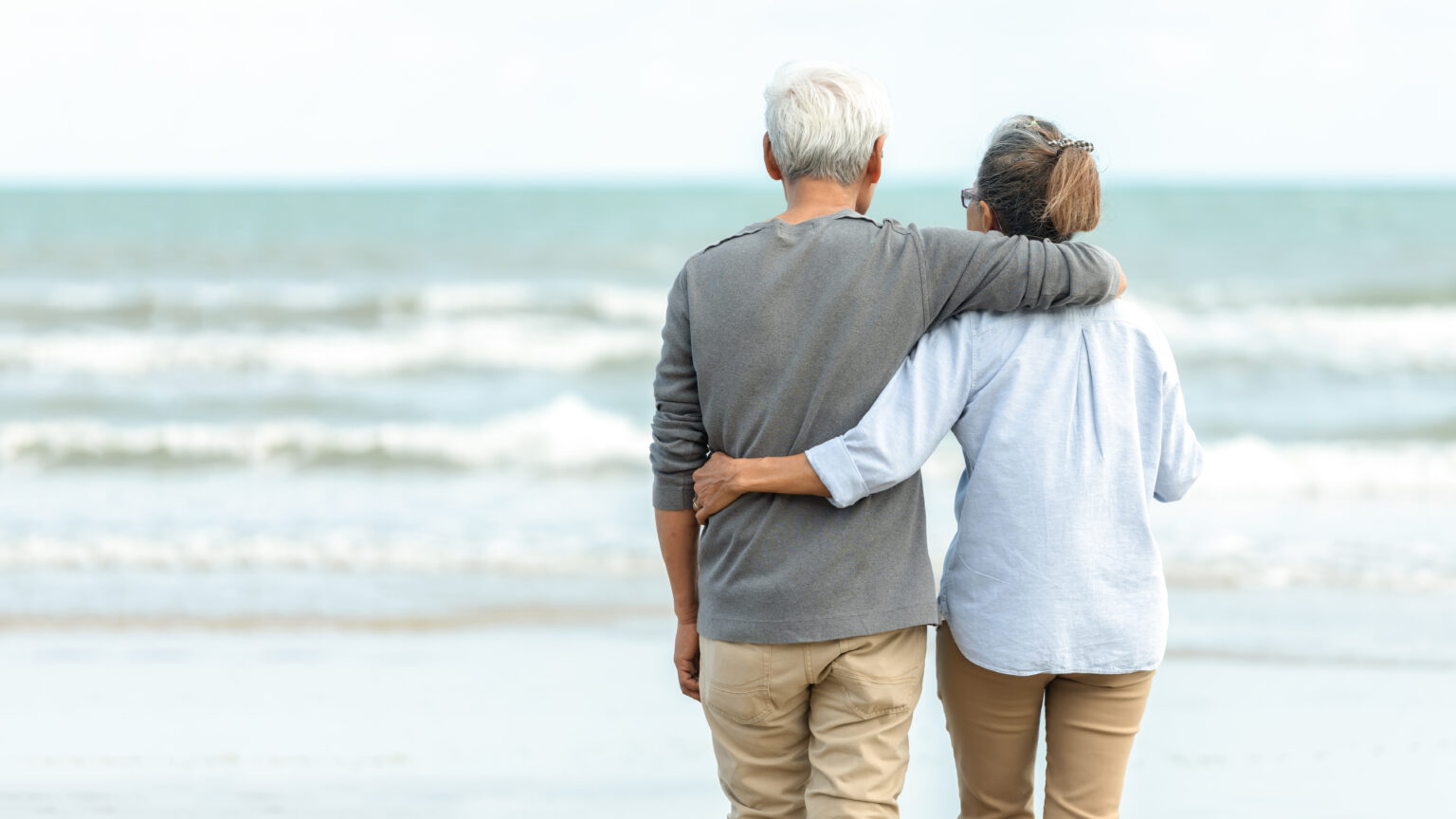 Asian Lifestyle senior couple hug and stand see beach happy in love romantic and relax time.  Tourism elderly family travel leisure destination and activity after retirement in vacations and summer.