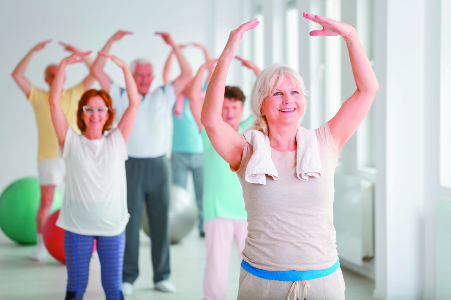 Group of happy seniors during warm up before exercise